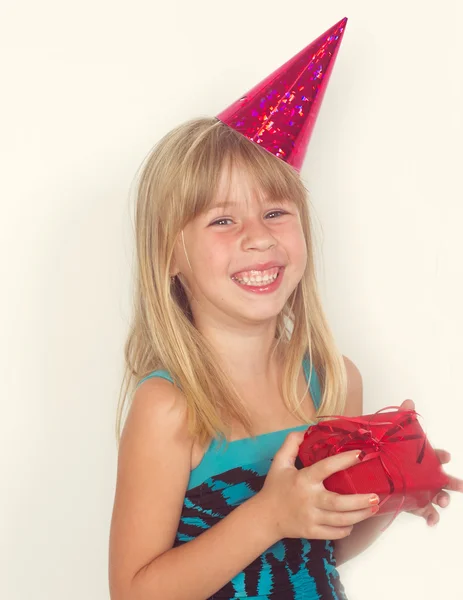 Girl with a birthday gift and cap — Stock Photo, Image
