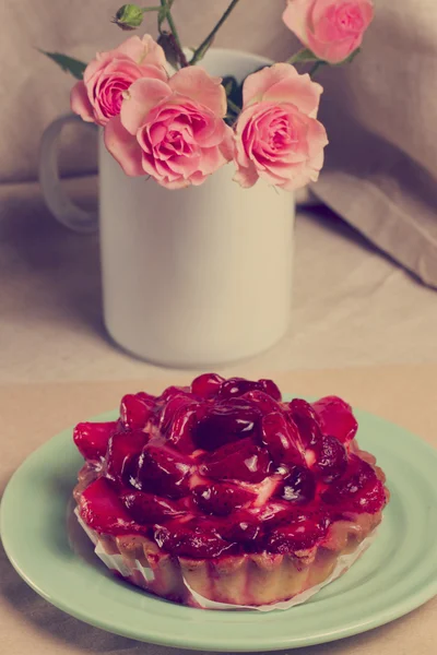 Jordgubbs tårta och bukett rosor — Stockfoto
