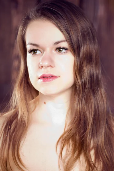 Portrait of a girl on wooden wall — Stock Photo, Image