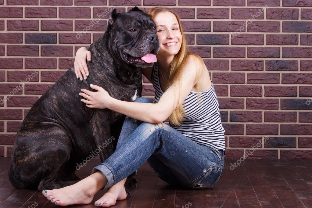 Girl hugging a big dog Cane Corso — Stock Photo © victoshafoto