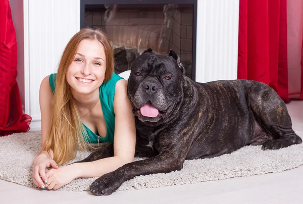 Girl is at home with his dog Cane Corso — Stock Photo, Image