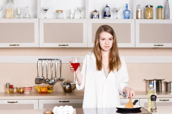 Girl long flowing hair in a man's shirt.  kitchen with glass of  wine — Stock Photo, Image