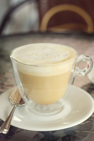 Cup of cappuccino on the table in cafe — Stock Photo, Image