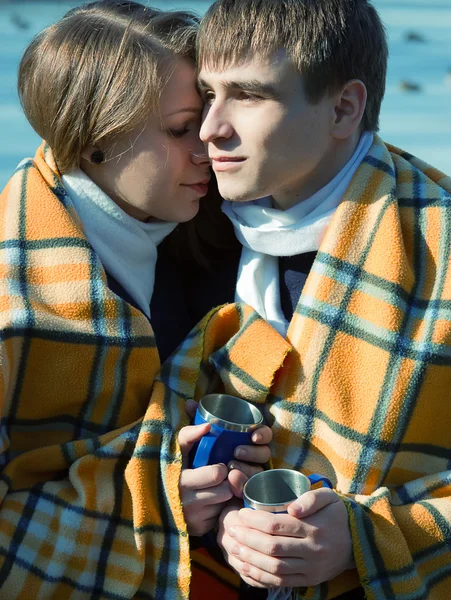 Loving couple in blanket in winter drink tea — Stock Photo, Image