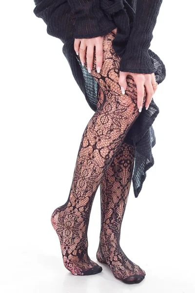 Vrouw voeten met fishnet kousen — Stockfoto