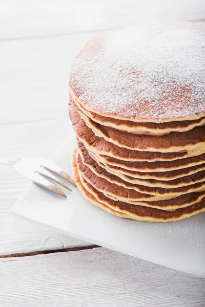 Stack of pancakes with powdered sugar — Stock Photo, Image