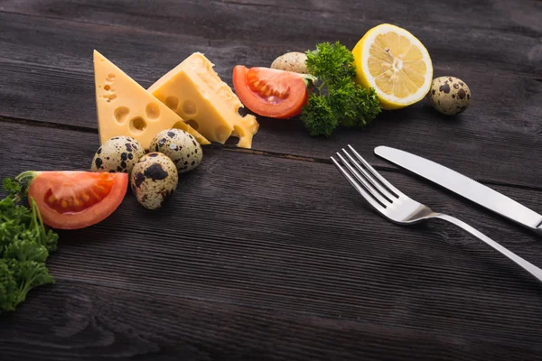 Fork and knife with tomato, cheese, eggs — Stock Photo, Image