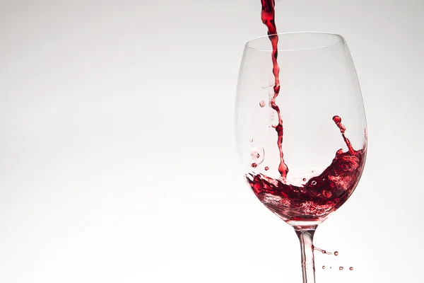 Pouring red wine into glass — Stock Photo, Image