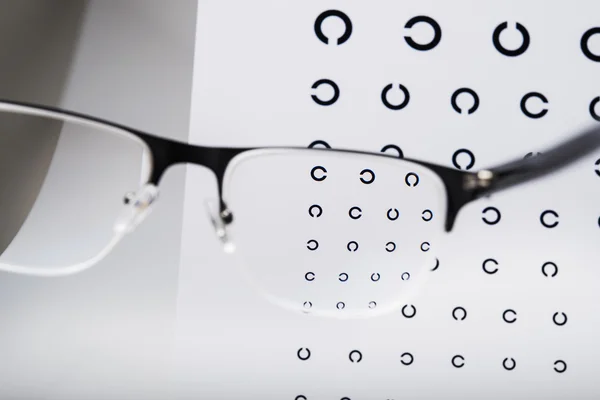 Eyeglasses and focus exam test — Stock Photo, Image