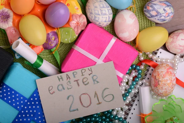 Easter eggs with flowers and gift box — Stock Photo, Image