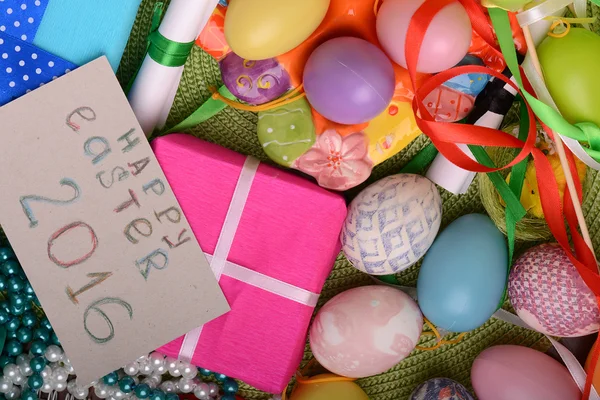 Easter eggs with flowers and gift box — Stock Photo, Image