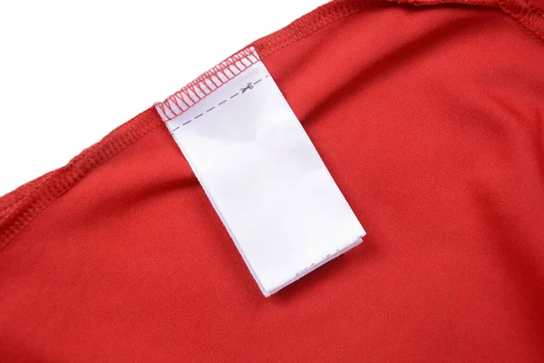 White blank clothing tag label on shirt fabric texture background