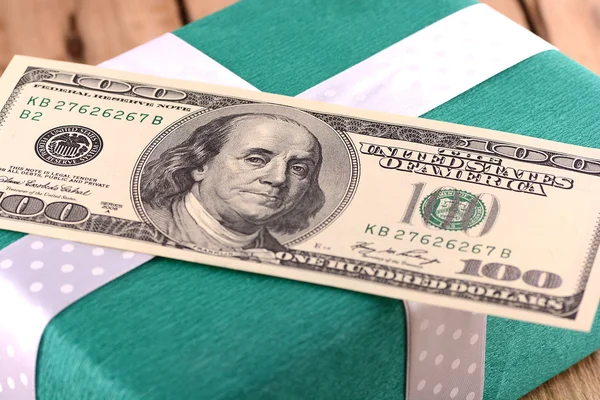 Holiday bonus.  american money on green gift box — Stock Photo, Image