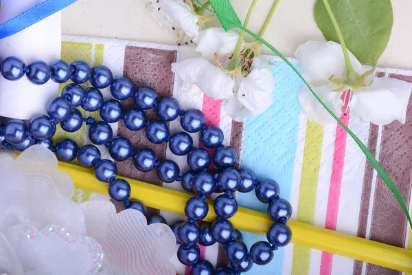 Office table with flower, ribbons, pencils, pearls — Stock Photo, Image