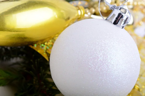 Festive golden christmas decoration, candles, white balls, green fir tree branch, close up — Stock Photo, Image