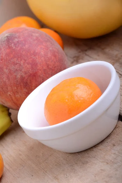 Mandarin Apples Bananas Peach on wooden plate — Stock Photo, Image