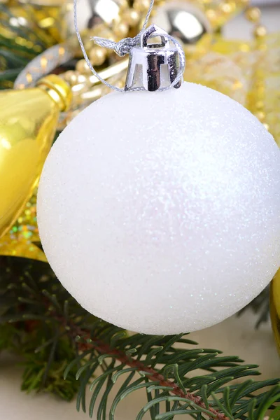 Festive golden christmas decoration, candles, white balls, green fir tree branch, close up — Stock Photo, Image