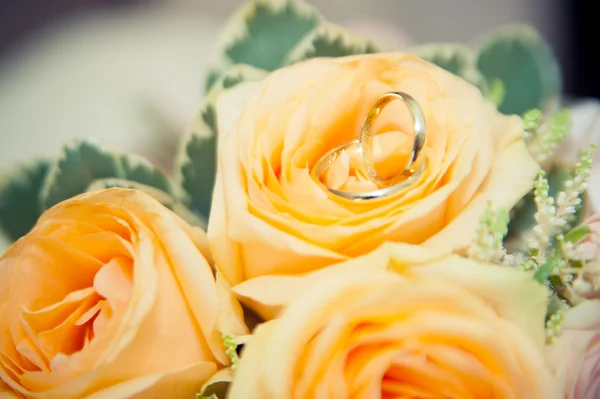 Wedding rings lie on a bouquet — Stock Photo, Image