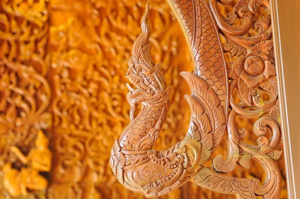 Beautiful Naga teak wood carving sculptures in Thai temple. — Stock Photo, Image