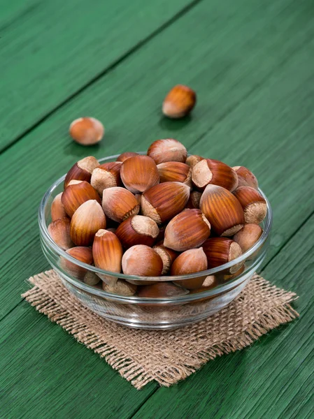 Hazelnut on a green table — Stock Photo, Image