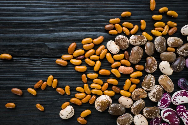 Color haricots on wooden table — Stock Photo, Image