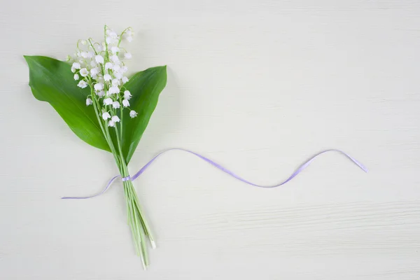 Lelies van de vallei op een witte tafel — Stockfoto