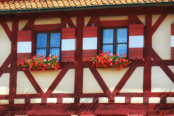 House with wooden windows with flowers — Stock Photo, Image