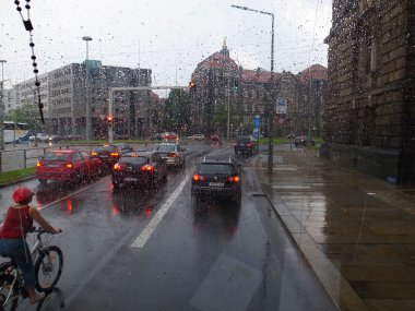 Bisikletçi, otomobil, otobüs Dresden yağmurda