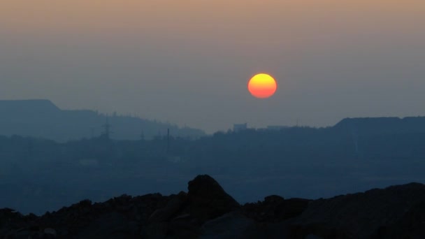 Untergehende Sonne über einer Grube — Stockvideo