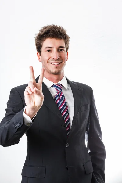 Jovem empresário mostrando gesto e expressão facial — Fotografia de Stock