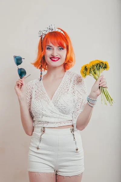 Young woman with a bouquet of dandelions — Stock Photo, Image