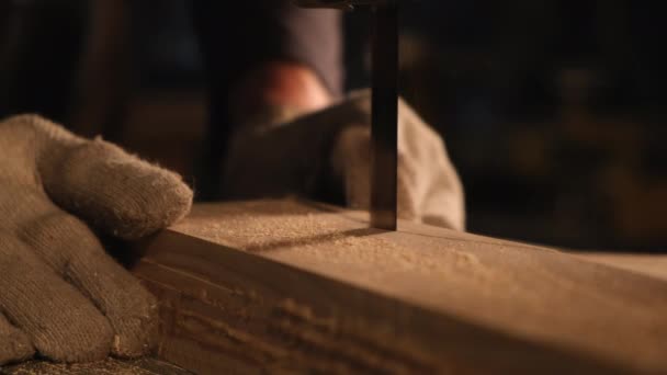 Close-up of a carpenter with gloves and a band saw — Stock Video
