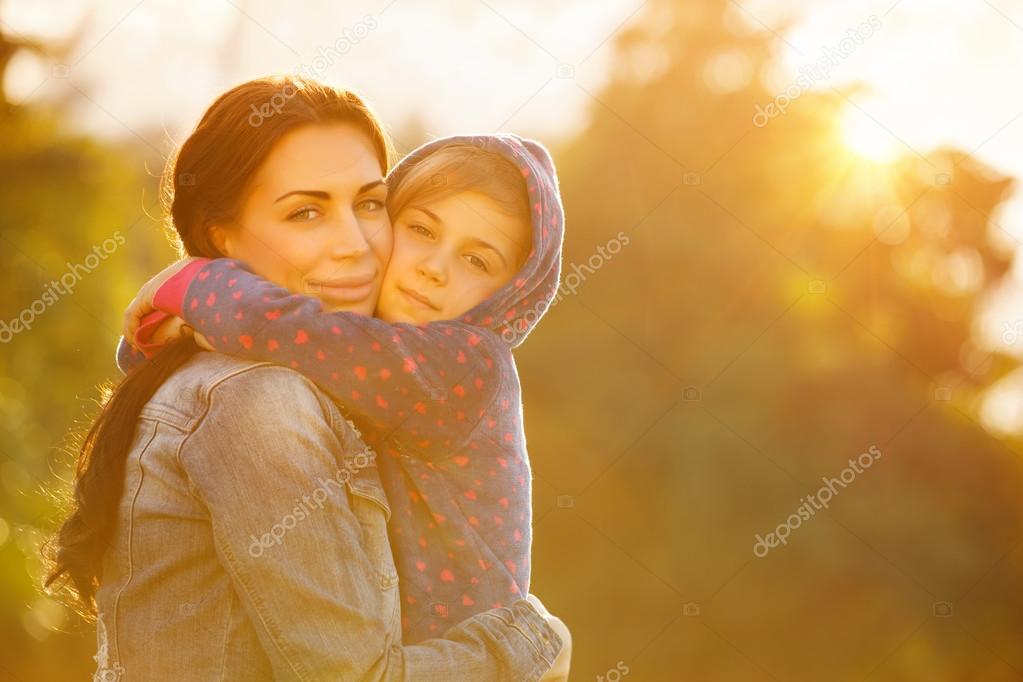 Happy mother hugging daughter