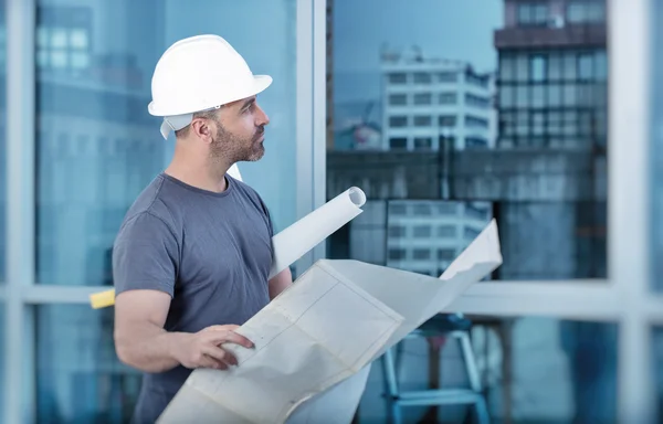 Architect builder studying layout plan of the rooms