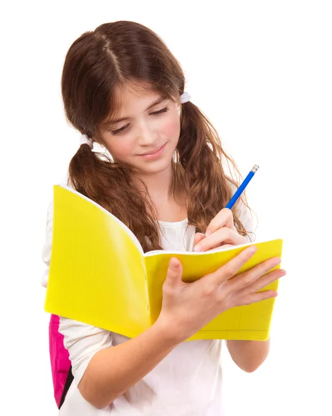 School girl writing in notebook — Stock Photo, Image