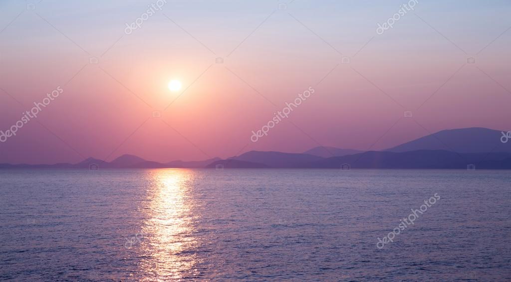 Beautiful purple sunset on the sea, sun reflection on peaceful water, wonderful landscape, scene destination, beauty of nature concep