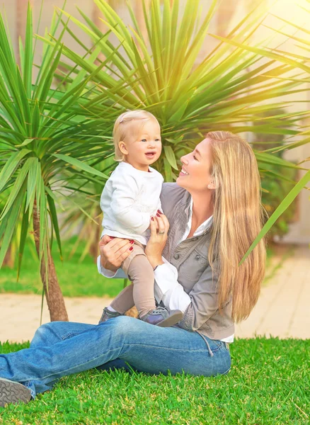 Young happy family on backyard — Stock Photo, Image