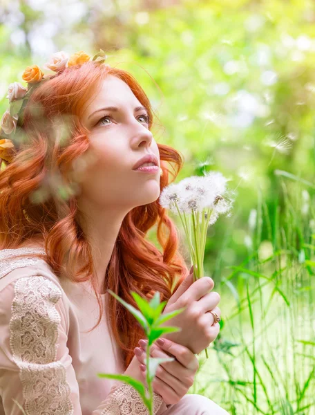 Dreamy woman with dandelions — Stock Photo, Image