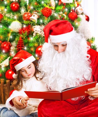Little girl with Santa read book