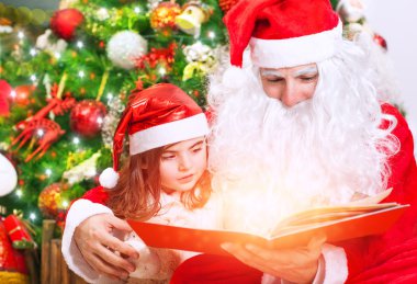 Little girl with Santa read book
