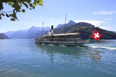 Lake Lucerne, Switzerland - August 26, 2020: Unterwalden paddle steamer sails to the next place and can be seen on the waters of the lake and has just set sail from the city of Brunnen.