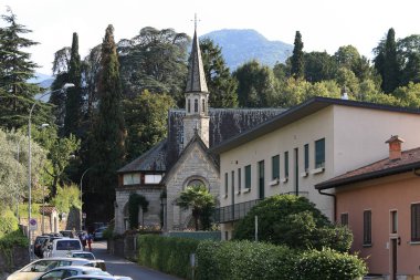 Bellagio, Italy - July 11, 2009: An old stone church is visible in a narrow street, or maybe it is already a modern residential building.