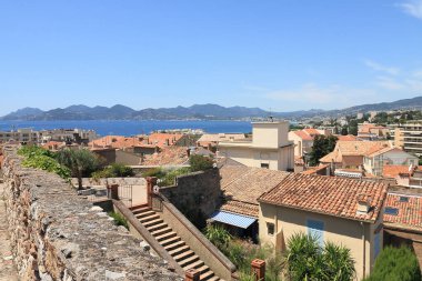 Cannes, France - July 09, 2009: Ceramic tiles cover the roofs of residential houses, which is visible from a hill near the Mediterranean Sea.