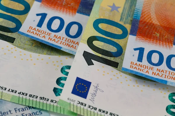 The euro banknotes and Swiss paper money placed together express the relationship between the Swiss franc and the currency of the European Union. EUR and CHF currencies.
