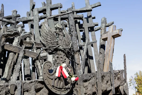 Monument with crosses and the emblem of Poland — Stock Photo, Image
