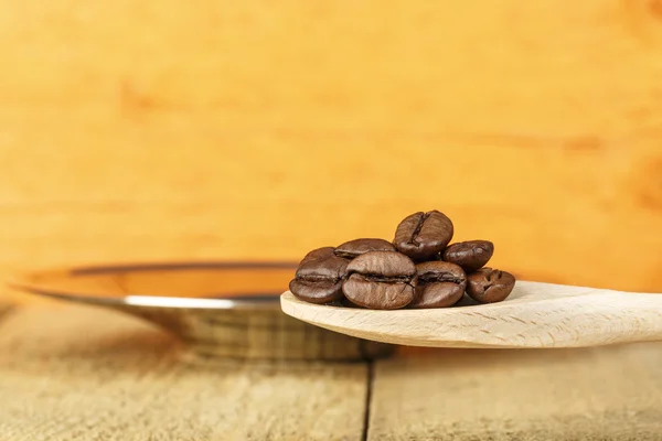 Coffee beans in a wooden spoon — Stock Photo, Image