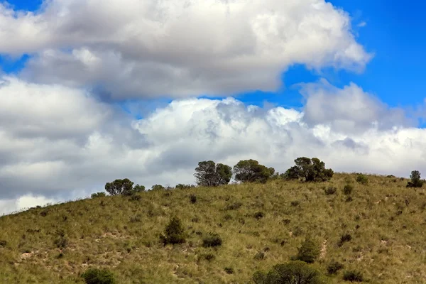 Low altitude mountain arid zone and blue sky with clouds — Stock Photo, Image