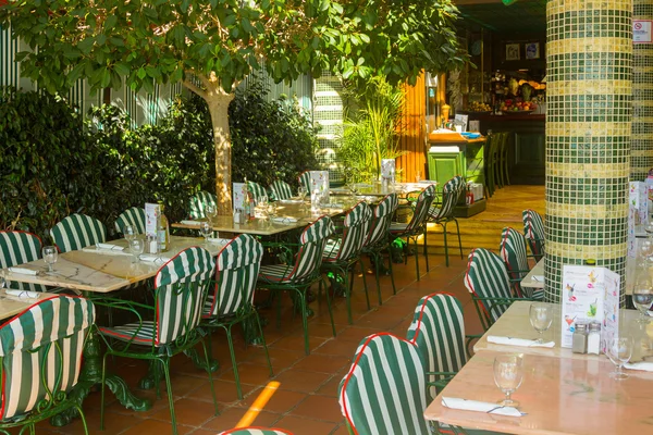 restaurant tables with silverware and glasses ready for a lunch