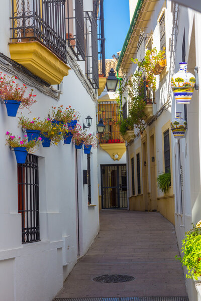 Streets decorated with flowers and barred windows typical of the