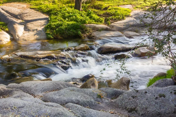 Silky waterfall on a small river at sunset — Stock Photo, Image